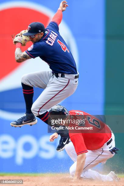 Carlos Correa of the Minnesota Twins forces out Owen Miller of the Cleveland Guardians at second base during the third inning at Progressive Field on...