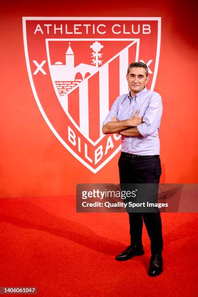 The new coach of Athletic Club Ernesto Valverde poses next to the Athletic Club shield during his presentation at the San Mamés stadium on June 30,...