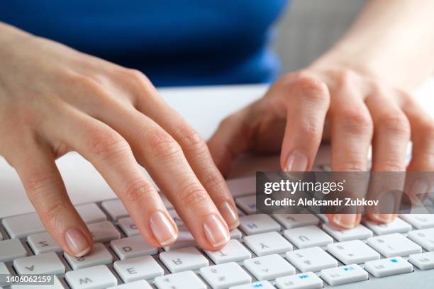 female hands type text on the keyboard of a computer or laptop. a woman, an office worker at her desk. the concept of business, freelancing, work at home. it support, network security, online social support. distance learning online. - zuhause-bleiben-anordnung stock-fotos und bilder