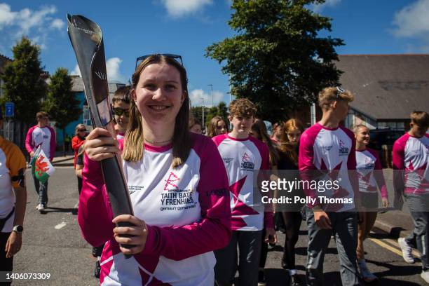 Baton bearer holds the Queen's Baton during the Birmingham 2022 Queen's Baton Relay on June 29, 2022 in Aberystwyth, United Kingdom.
