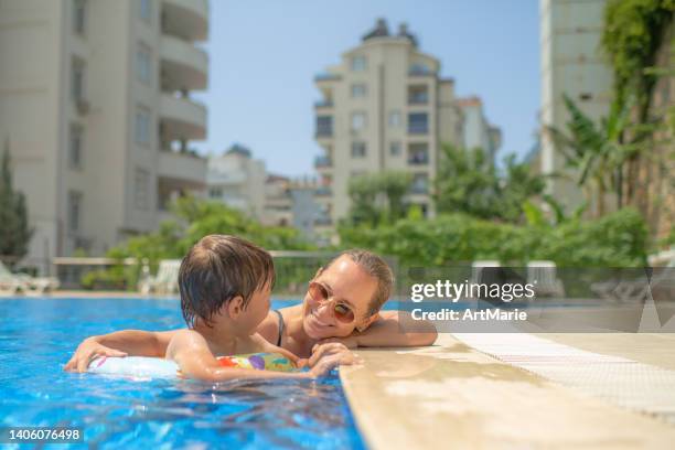 happy child and mother in pool - kids pool games stock pictures, royalty-free photos & images