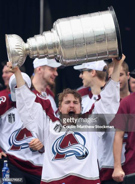 Nicolas Aube-Kubel of the Colorado Avalanche lifts the Stanley Cup on-stage during the Colorado Avalanche Victory Parade and Rally at Civic Center...