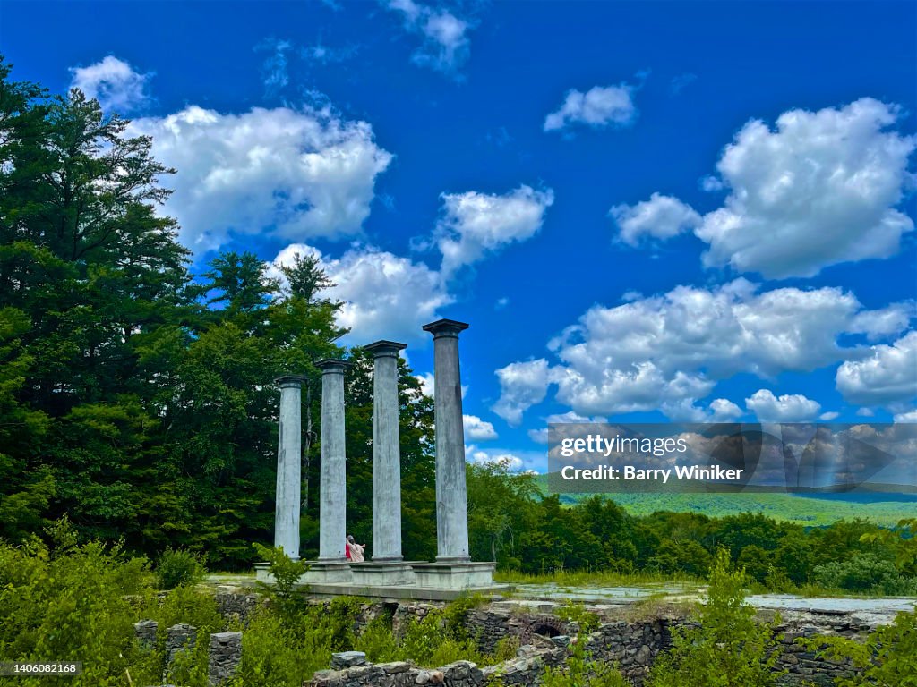 People talking under tall columns in The Berkshires