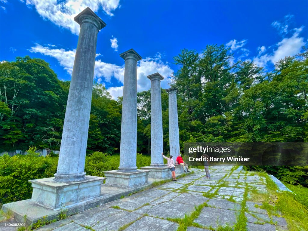 People talking under tall columns in The Berkshires