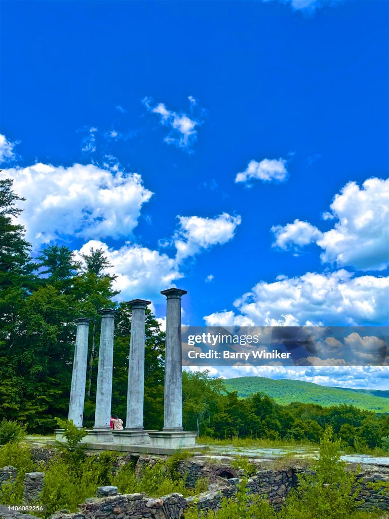 People talking under tall columns in The Berkshires