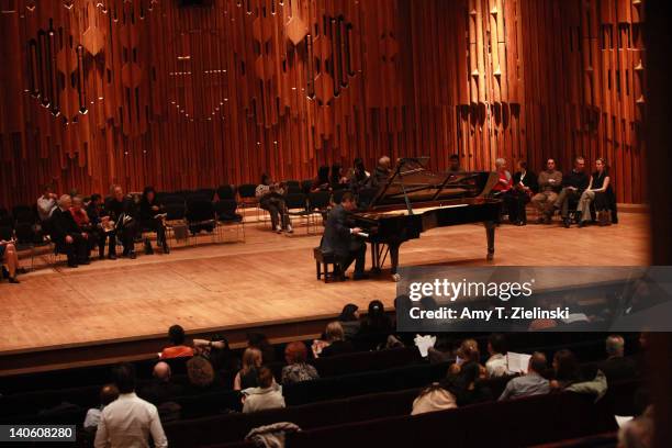 Piano tuner works on a Steinway at interval during a performance by Russian pianist Evgeny Kissin who performed a solo piano recital with works by...