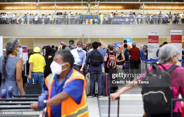 Travelers gather in the international terminal at Los Angeles International Airport on June 30, 2022 in Los Angeles, California. Flight cancellations...