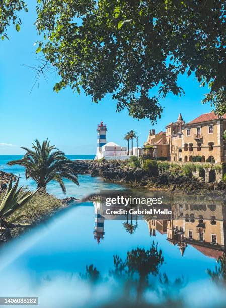 mirror reflections of santa marta lighthouse - cascais stockfoto's en -beelden