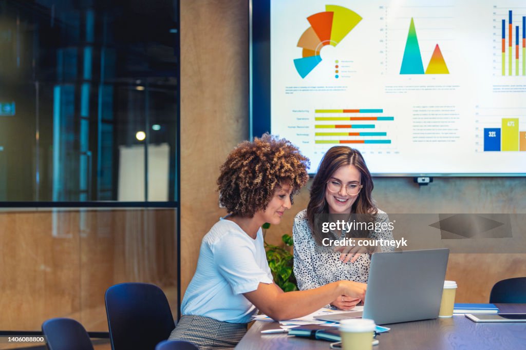 Business colleagues working together on a laptop.