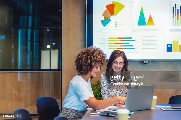 business colleagues working together on a laptop. - business finance and industry stock pictures, royalty-free photos & images