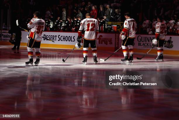 Mike Cammalleri, Jarome Iginla, Jay Bouwmeester and Derek Smith of the Calgary Flames stand attended for the Canadien National Anthem before the NHL...