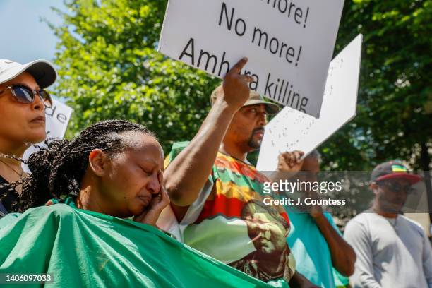 Woman from the Ethiopian community cries alongside other community members during a demonstration to bring awareness to the mass ethnic cleansing of...