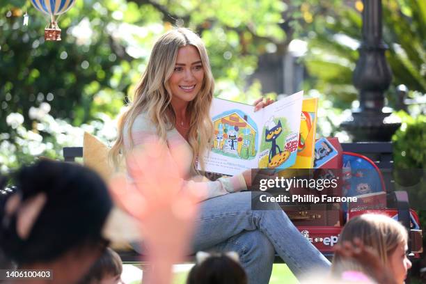 Hilary Duff reads during Epic!'s Go Anywhere Summer Kickoff Celebration supporting St. Jude at The Grove on June 30, 2022 in Los Angeles, California.