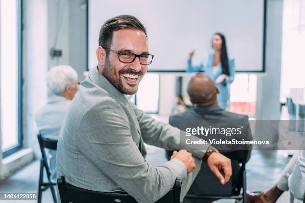 confident businessman attending a seminar. - boss over shoulder stock pictures, royalty-free photos & images