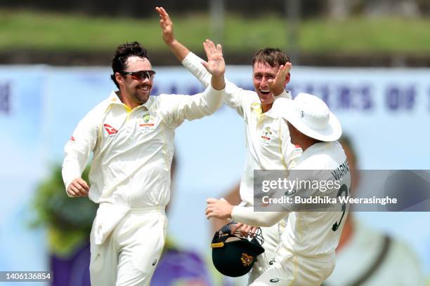 Travis Head of Australia celebrates with teammates after dismissing Dinesh Chandimal of Sri Lanka during day three of the First Test in the series...