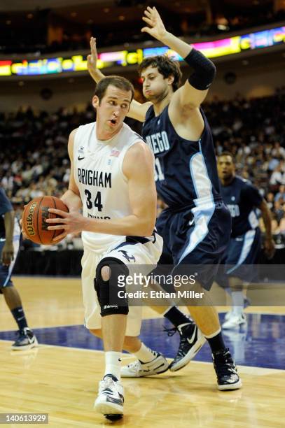 Noah Hartsock of the Brigham Young Cougars posts up against John Sinis of the San Diego Toreros during a quarterfinal game of the Zappos.com West...