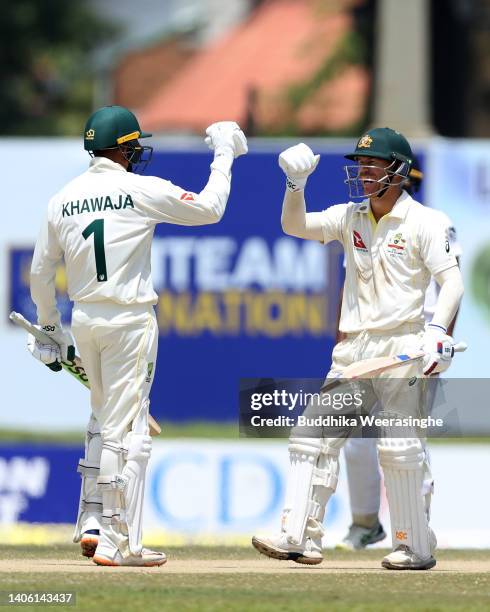 David Warner of Australia celebrates with Usman Khawaja after their win during day three of the First Test in the series between Sri Lanka and...