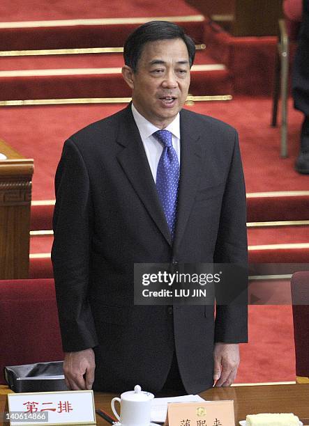 Chongqing Mayor Bo Xilai sings the national anthem during the opening session of the 11th National Committee of the Chinese People's Political...