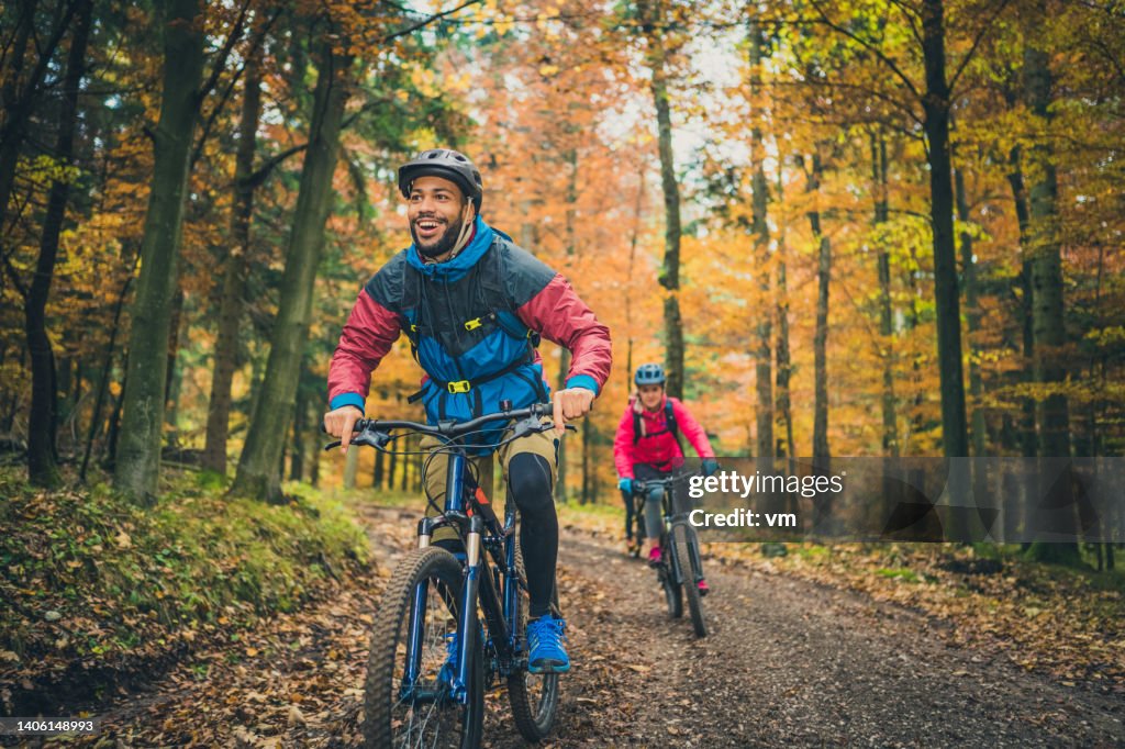Smiling young black man enjoying sport with friends in nature