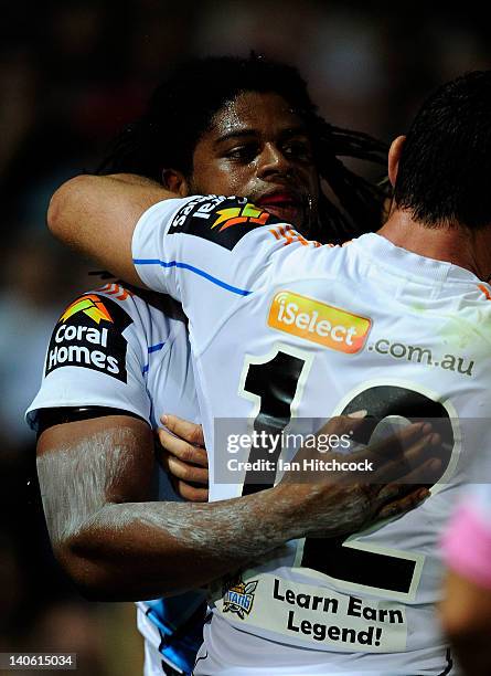 Jamal Idris of the Titans is congratulated by Mark Minichiello after scoring the first try during the round one NRL match between the North...