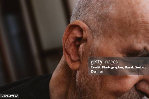 close-up of a senior man's ear - human ear close up stock pictures, royalty-free photos & images