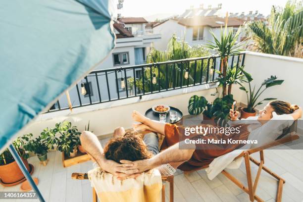 couple relaxing on the balcony. - terras stockfoto's en -beelden