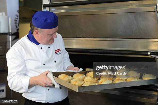 Head chef Tony Henshaw takes freshly baked pasties out of the oven at the World Cornish Pasty Championships at The Eden Project on March 3, 2012 in...