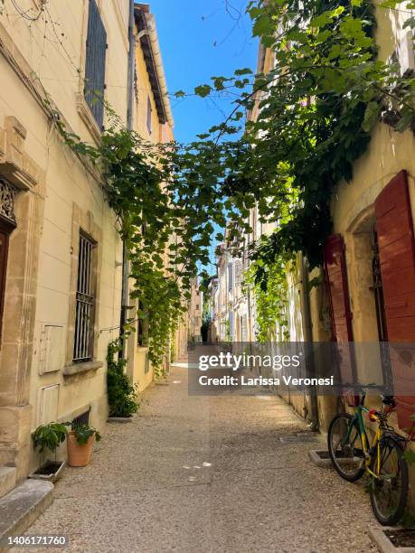 picturesque street in arles old town, provence, france - arles stock-fotos und bilder