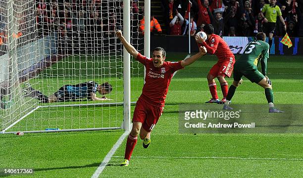 Stewart Downing of Liverpool celebrates the own goal scored by Laurent Koscielny of Arsenal during the Barclays Premier League match between...