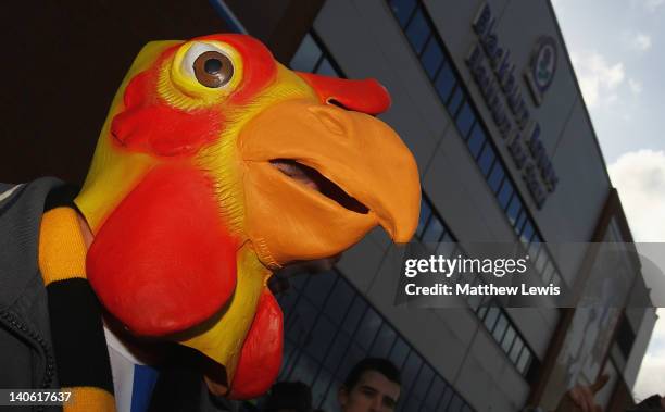 A Blackburn Rovers supporter wears a chicken mask in protest to the Blackburn Rorvers owners during the Barclays Premier League match between...