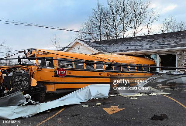 School bus is lodged in a home where it came to rest after being tossed by yesterday's tornado March 3, 2012 in Henryville, Indiana. Dozens of people...