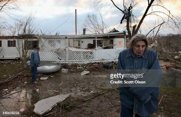 Steve Smith and J. J. Smith survey the damage to their home following yesterday's tornado March 3, 2012 in Henryville, Indiana. Dozens of people were...