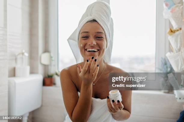 i love applying moisturizer - moisturizer stock pictures, royalty-free photos & images