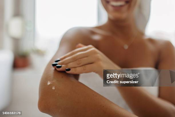 don't forget to moisturize your skin - touching elbows stock pictures, royalty-free photos & images