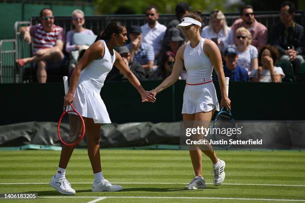 Naiktha Bains and partner Maia Lumsden of Great Britain interact during their Women's Doubles Second Round match against Shuko Aoyama of Japan and...