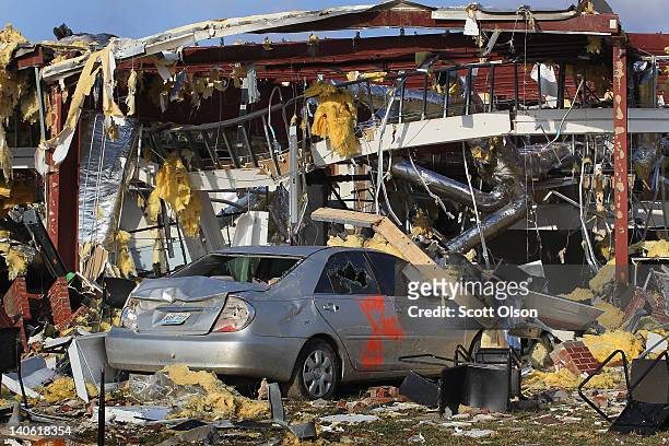 Car sits under a collapsed section of the Henryville school after a tornado ripped through town March 3, 2012 in Henryville, Indiana. Dozens of...
