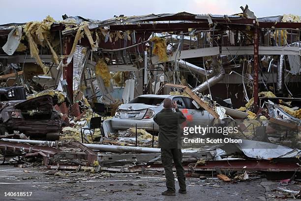 Man photographs a collapsed section of the Henryville school after a tornado ripped through town March 3, 2012 in Henryville, Indiana. Dozens of...