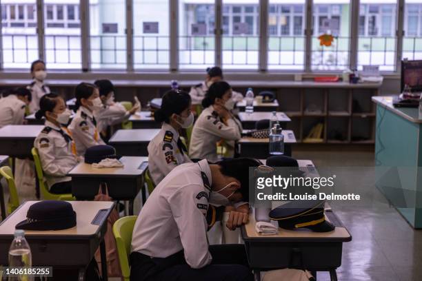 Students in a classroom after a flag-raising ceremony to celebrate the 25th anniversary of the handover at a school on July 01, 2022 in Hong Kong,...
