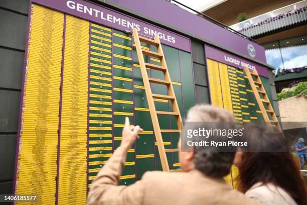Spectators inspect the scoreboard on day five of The Championships Wimbledon 2022 at All England Lawn Tennis and Croquet Club on July 01, 2022 in...