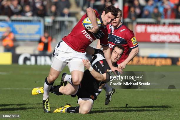 Tom Brady of Sale Sharks is held up by Haydn Thomas of Exeter during the Aviva Premiership match between Exeter Chiefs and Sale Sharks at Sandy Park...