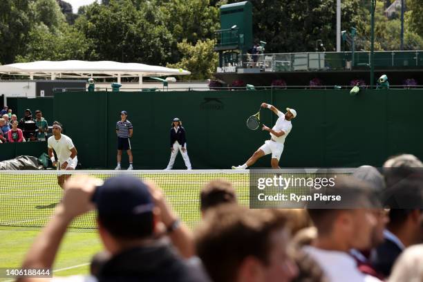 Juan Sebastian Cabal serves with partner Robert Farah of Colombia against Nuno Borges and Francisco Cabral of Portugal during their Men's Doubles...