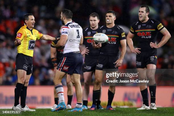 James Tedesco of the Roosters speaks to referee Gerard Sutton during the round 16 NRL match between the Penrith Panthers and the Sydney Roosters at...