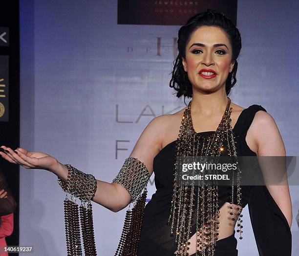 Indian Bollywood actress Nargis Bagheri displays creation by designer Mona Shroff during the second day of Lakme Fashion Week summer resort 2012 in...