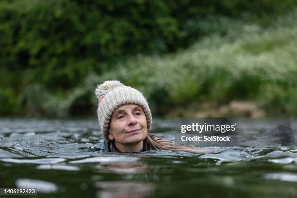 open water solo swimming - people swim river stockfoto's en -beelden