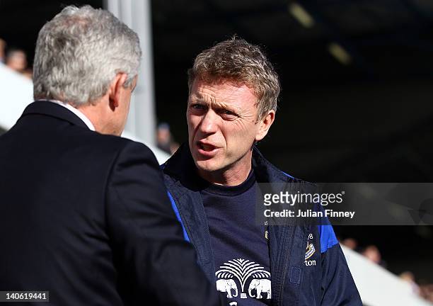 Manager, David Moyes of Everton meets Mark Hughes of QPR during the Barclays Premier League match between Queens Park Rangers and Everton at Loftus...