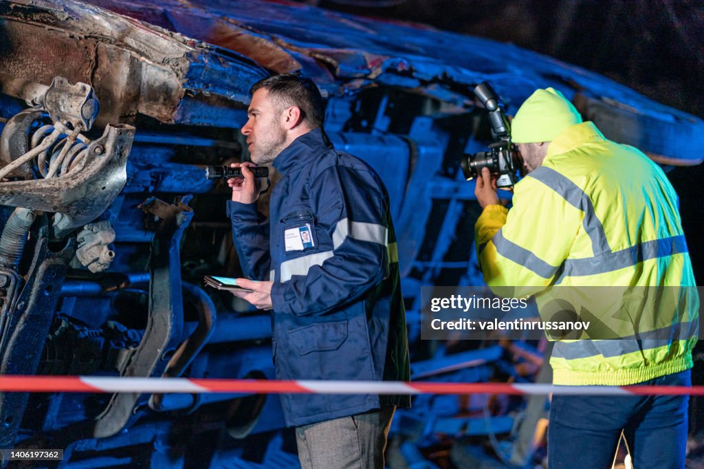 Investigating police officer are inspecting the crash site