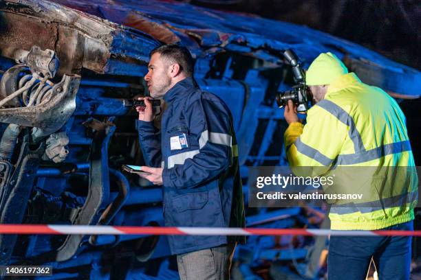 Investigating Police Officer Are Inspecting The Crash Site High-Res Stock Photo