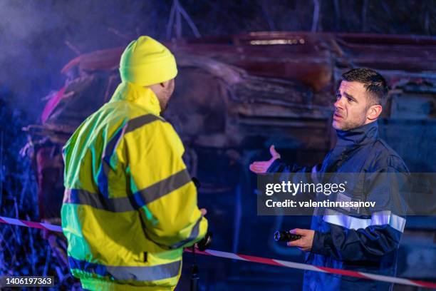 Investigating Police Officer Are Inspecting The Crash Site High-Res Stock Photo