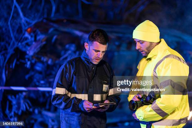 investigating police officer are inspecting the crash site - commanders stockfoto's en -beelden