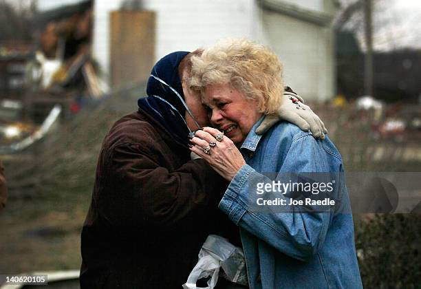 Janine Stauffacher comforts her sister, Mary Ann Holt, after she survived in the closet of her home, which was hit by a tornado that passed through...